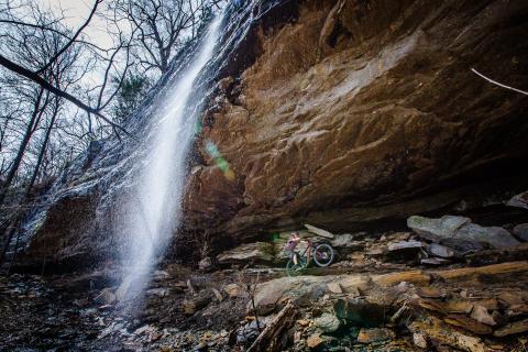 Mountain bike trail built under a waterfall