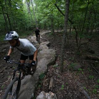 two people biking on rock section of best trail ever